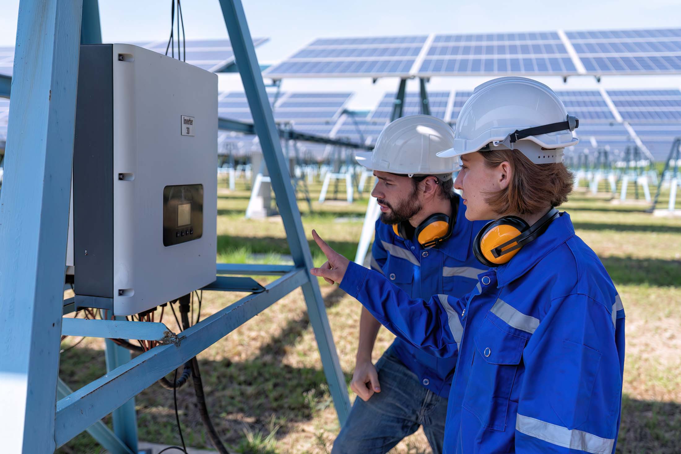 Maintenance engineer at solar farm trouble shooting looking at i