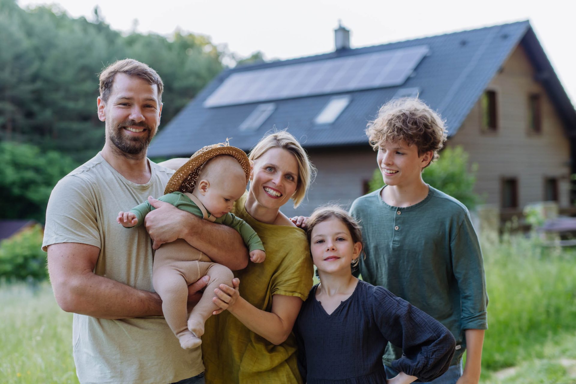 happy family near their house with solar panels a 2023 11 27 05 20 07 utc